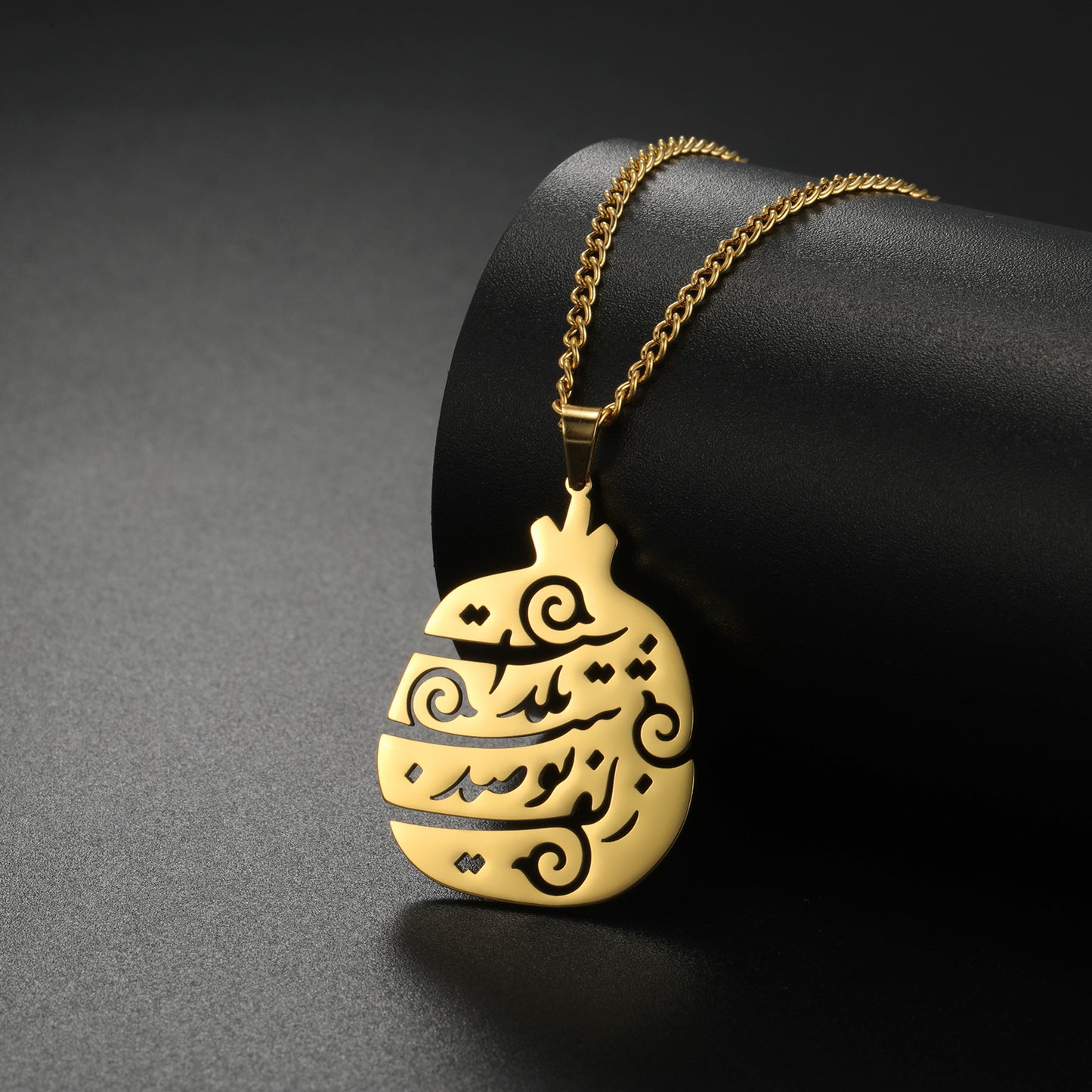 Myshape Yalda calligraphy necklace placed inside a jewelry gift box, stainless steel Persian poem pendant.