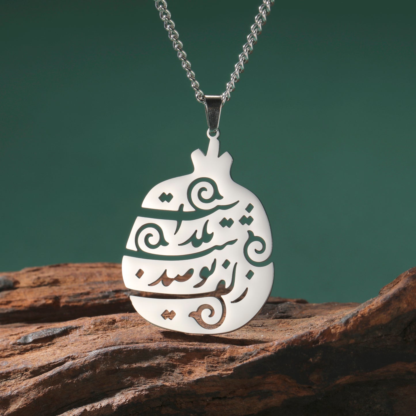Close-up of stainless steel Persian poem pendant featuring Yalda Farsi calligraphy engraving.
