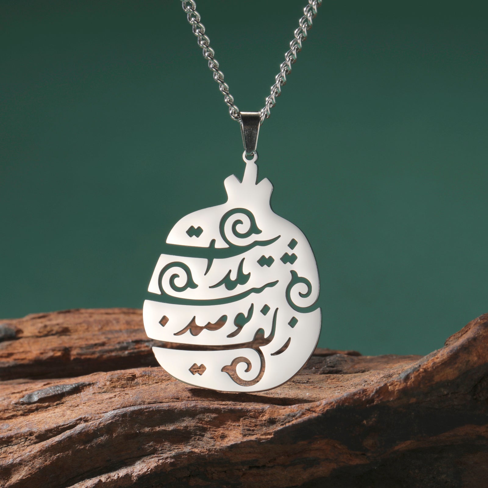 Close-up of stainless steel Persian poem pendant featuring Yalda Farsi calligraphy engraving.