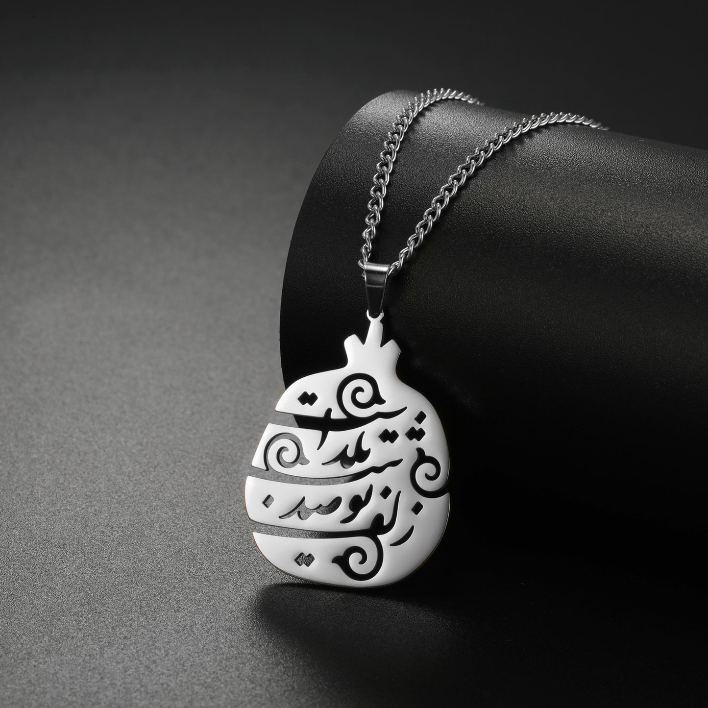 Yalda Persian poem necklace displayed on a neutral background, showcasing Farsi calligraphy design.